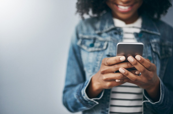 Woman looking at website on her phone at Cascade Dental in Medford, OR