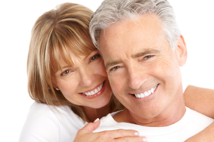 Mature couple smiling with arms holding each other at Cascade Dental in Medford, OR